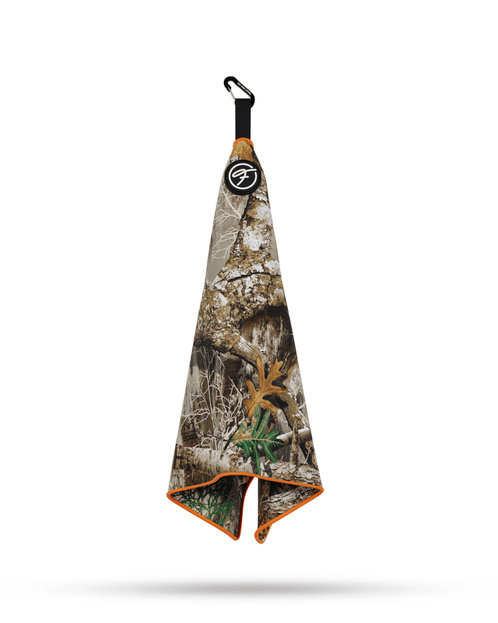 Realtree Orange Magnetic Golf Towel hanging securely by metal clip for easy access. #color_realtree-orange